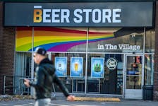A pedestrian passes a Beer Store in downtown Toronto. 