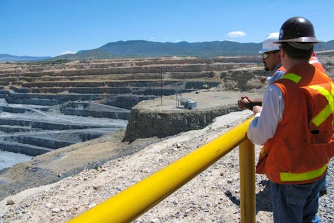 Engineers stand next to the open pit gold mine of Goldcorp in Penasquito September 18, 2012. 