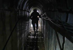 Lt. Col. Ido, whose last name was redacted by the military, walks inside a tunnel underneath the UNRWA compound, where the military discovered tunnels in the main headquarters of the U.N. agency that the military says Hamas militants used to attack its forces during a ground operation in Gaza, Thursday, Feb. 8, 2024. The Israeli military says it has discovered tunnels underneath the main headquarters of the U.N. agency for Palestinian refugees in Gaza City, alleging that Hamas militants used the space as an electrical supply room. The unveiling of the tunnels marked the latest chapter in Israel's campaign against the embattled agency, which it accuses of collaborating with Hamas.