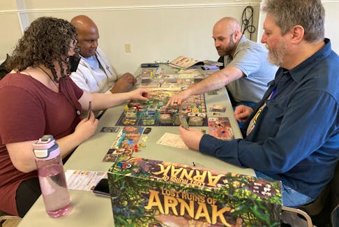Kim O'Connor, Lloyd Powell, Jeff Reeves and Mike Jorgensen (from front left) play a game during a event held by the Kings Tabletop and Boardgame Society in Kentville Saturday, The group says the popularity of the games has been growing in recent years. - Ian Fairclough