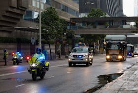 Police escort a prison van that is believed to carry media mogul Jimmy Lai, founder of Apple Daily, to the District Court in Hong Kong, China November 24, 2022.