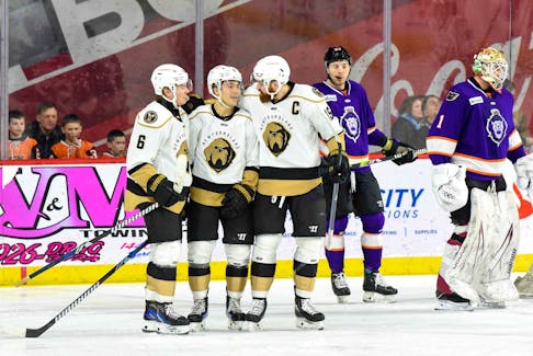 Tate Singleton, middle, Todd Skirving, right, and Brock Caufield celebrate a goal scored by Singleton during a 2-1 loss to the Reading Royals on Monday, Feb. 19