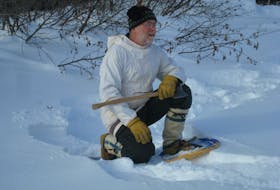 Bernie Crawford hunts for the perfect birch tree. He'll use it to make snowshoes. - Contributed