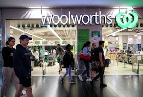 People walk past a Woolworths supermarket in Sydney, Australia, June 16, 2020.