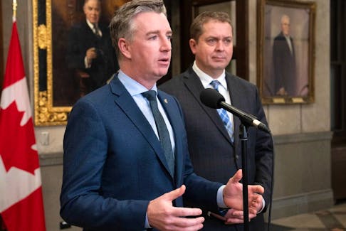 Conservative House leader Andrew Scheer listens to Ethics and Accountable Government critic Michael Barrett speak to reporters in the House of Commons foyer in Ottawa, Tuesday, February 20, 2024.