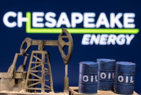 A 3D printed oil barrels and oil pump jack are seen in front of displayed Chesapeake Energy logo in this illustration taken January 25, 2022.