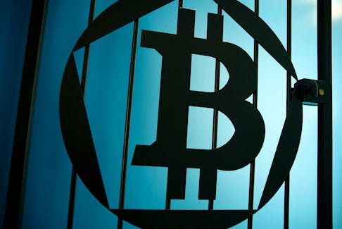 A bitcoin logo is pictured on a door in an illustration picture taken at La Maison du Bitcoin in Paris May 27, 2015.