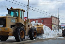 A motorist travelling along Victoria Road veers away from a tractor clearing away a snowbank on Tuesday in Whitney Pier — remnants left over from the massive snowstorm from Feb. 2-5 as well as a second snowstorm from last week. IAN NATHANSON/CAPE BRETON POST