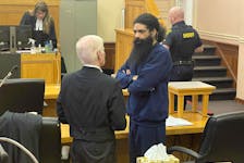 Stephen Hopkins (right) speaks with amicus curiae John Brooks in Newfoundland and Labrador Supreme Court in St. John's Monday, February 19, 2024.