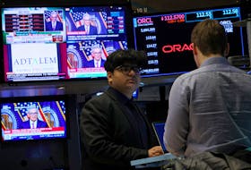 Traders work, as screens display a news conference by Federal Reserve Board Chairman Jerome Powell following the Fed rate announcement, on the floor of the New York Stock Exchange (NYSE) in New York City, U.S., January 31, 2024.