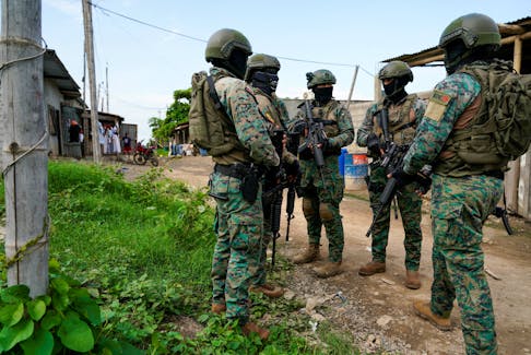 Soldiers stand together during a joint police and military operation in a low-income neighbourhood, as the government continues its offensive against criminal gangs, in Duran, Ecuador, February 1, 2024.