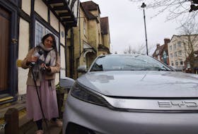 Clare Tan gets ready to charge her electric BYD Atto 3 using a home charger that she rents via peer-to-peer charging app Co Charger in Berkhamsted, Britain, January 31, 2024.