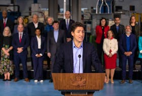 Prime Minister Justin Trudeau, joined by members of the Liberal Cabinet, speaks to the media at the McMaster Automotive Resource Centre, in Hamilton, Ont., during the final day of meetings at the Liberal Cabinet retreat, on Jan. 25, 2023. 