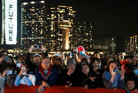People watch the fireworks show over the Victoria Harbour on the second day of the Lunar New Year of the Dragon, in Hong Kong, China February 11, 2024.
