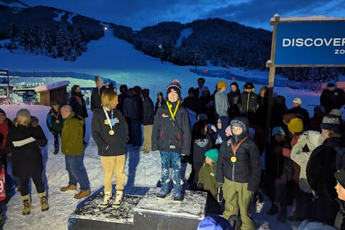 Willem Reijers, centre, stands on top of the podium after winning a gold medal in the under-12 age category at the Timber Tour Super Youth mogul competition at Panorama Mountain Resort in British Columbia recently. Reijers is from Stratford, P.E.I. Contributed