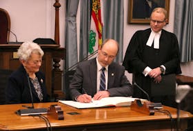 Matt MacFarlane, centre, is sworn in as the MLA for Borden-Kinkora at the P.E.I. legislature in Charlottetown on Feb. 21 by P.E.I. Lt.-Gov. Antoinette Perry, left, and Joey Jeffrey, clerk of the legislative assembly. MacFarlane, who ran for the Green party, won a byelection on Feb. 7. His win brings the total number of Green seats in the legislature to three. The spring sitting of the P.E.I. legislature will begin Feb. 27. Stu Neatby • The Guardian