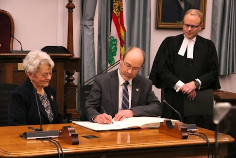 Matt MacFarlane, centre, is sworn in as the MLA for Borden-Kinkora at the P.E.I. legislature in Charlottetown on Feb. 21 by P.E.I. Lt.-Gov. Antoinette Perry, left, and Joey Jeffrey, clerk of the legislative assembly. MacFarlane, who ran for the Green party, won a byelection on Feb. 7. His win brings the total number of Green seats in the legislature to three. The spring sitting of the P.E.I. legislature will begin Feb. 27. Stu Neatby • The Guardian