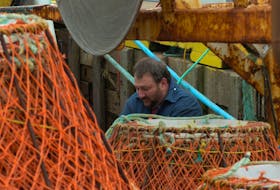Bruce Poole was hard at work Tuesday as he and fellow crewmates prepred crab pots for the upcoming crab fishery. He said ice conditions were poor and may impede their efforts.— Photo by Keith Gosse/The Telegram