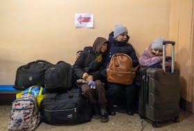 Lilya and her children Aryna and Katya, who fled their home in Novohrodivka after an increase in Russian missile strikes, wait for an evacuation train in Pokrovsk, Ukraine, amid Russia’s attack on Ukraine, February 20, 2024.