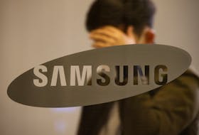 A man walks past the logo of Samsung at its office building in Seoul, South Korea, October 25, 2020.   