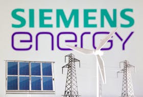Miniatures of windmill, solar panel and electric pole are seen in front of Siemens Energy logo in this illustration taken January 17, 2023.