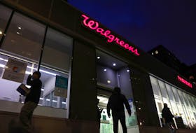People walk by a Walgreens, owned by the Walgreens Boots Alliance, Inc., in Manhattan, New York City, U.S., November 26, 2021.