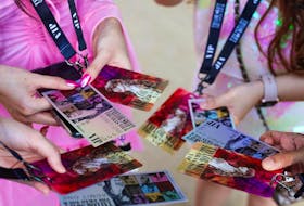 Taylor Swift fans, also known as "Swifties," take a photo of their tickets purchased for the show at Melbourne Cricket Ground on Feb. 16, 2024 in Melbourne, Australia.