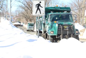 Snow being cleared along Cottage Road in Sydney gets dumped into a Cape Breton Regional Municipality public works truck on Wednesday. Snow-clearing efforts will be going on for weeks, according to CBRM Coun. Eldon MacDonald. IAN NATHANSON/CAPE BRETON POST