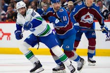  Vancouver Canucks left wing Arshdeep Bains, left, pursues the puck with Colorado Avalanche centre Andrew Cogliano in the first period on Tuesday in Denver.