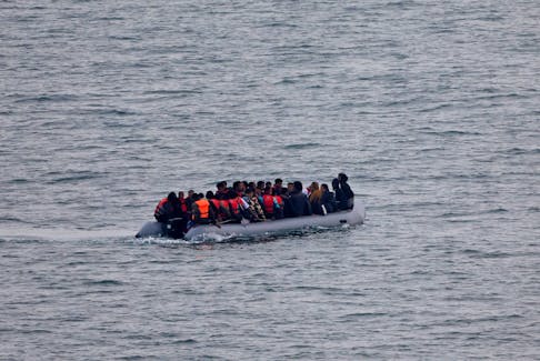 A group of migrants on an inflatable dinghy is seen from the French rescue vessel "Abeille Normandie" as they try to cross the English Channel from the coast of northern France, as warm weather and calm seas are favourable for crossings, France, October 2, 2023.