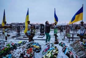Alona Onyshchuk, 39, visits her husband’s grave at the Alley of Heroes at a local cemetery, amid Russia's attack on Ukraine, in the village of Lozuvatka, Dnipropetrovsk region, Ukraine, January 22, 2024.