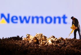 A small toy figure and gold imitation are seen in front of the Newmont logo in this illustration taken November 19, 2021.