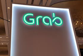 A Grab logo is pictured at the Money 20/20 Asia Fintech Trade Show in Singapore March 21, 2019. Picture taken March 21, 2019.
