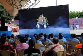 People watch a live stream of Chandrayaan-3 spacecraft's landing on the moon, inside an auditorium of Gujarat Science City in Ahmedabad, India, August 23, 2023.