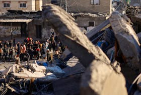 Palestinians inspect the site of an Israeli strike on a mosque and houses, amid the ongoing conflict between Israel and the Palestinian Islamist group Hamas, in Rafah in the southern Gaza Strip February 22, 2024.