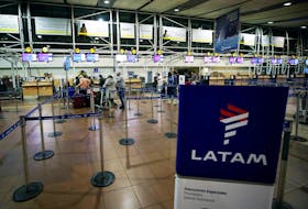 Passengers wait to check in for their flights at the departures area of Latam airlines inside the international airport in Santiago, Chile  August 16, 2018.