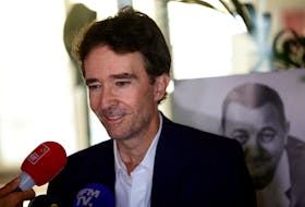 Antoine Arnault, overseeing Image and Environment for LVMH, talks to journalists, next to a poster with a portrait of late French comic Coluche, during a joint press conference at the headquarters of the charity food distribution Association "Les Restos Du Coeur" (Restaurants of the Heart) in Paris, after the French luxury group LVMH said on Monday it would contribute to the association and pledged 10 million euros, France, September 5, 2023.