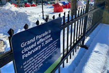A notice posted at Grand Parade with encampment in background in Halifax February 20, 2024
