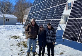 Aaron Jargo left, Christy Jargo, middle, and their son, Chase Muir, agree that installing ground-mounted solar arrays at their home in Murray River was an excellent long-term decision. Caitlin Coombes • Local Journalism Initiative reporter