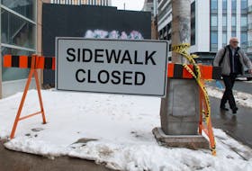 A pedestrian has to walk on a bike lane to get around a construction site on Hollis Street on Thursday, Feb. 22, 2024.
Ryan Taplin - The Chronicle Herald