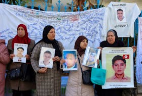 Family members of people lost at sea hold pictures of their missing relatives during a protest as it was the poor conditions that they believe drove their loved ones to their deaths at sea and demanding more work to retrieve their bodies, in Tunis, Tunisia February 6, 2024.