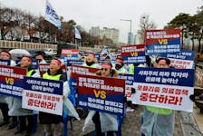 Doctors and Medical workers take part in a protest against a plan to admit more students to medical school, in front of the Presidential Office in Seoul, South Korea, February 21, 2024.