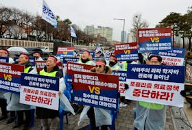 Doctors and Medical workers take part in a protest against a plan to admit more students to medical school, in front of the Presidential Office in Seoul, South Korea, February 21, 2024.