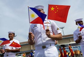Philippine Navy personnel wave the national flags of China and the Philippines as the Chinese naval training ship "Qi Jiguang" docks at the Port of Manila for a four-day goodwill visit, in Manila, Philippines, June 14, 2023.