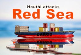 A cargo ship boat model is seen in front of "Red Sea" and "Houthi attacks" words in this illustration taken January 9, 2024.
