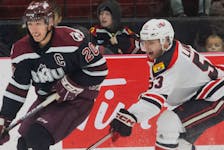 Saint Mary's captain Andrew Coxhead eludes the checking of UNB defenceman Kale Landry during an Atlantic university hockey game earlier this season in Fredericton. The Huskies and Reds will meet in the best-of0five conference semifinals beginning Friday at UNB. - UNB Athletics