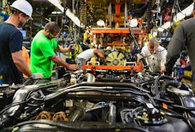 Workers assemble a Ford truck at the new Louisville Ford truck plant in Louisville, Kentucky, U.S. September 30, 2016. 