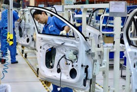Employees work on assembling vehicles at a plant of SAIC Volkswagen in Urumqi, Xinjiang Uighur Autonomous Region, China September 4, 2018.  China Daily via
