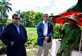 Ted McKinney, CEO of the National Association of State Departments of Agriculture (NASDA), listens to a Cuban farmer during a visit by NASDA members to a farm cooperative on the outskirts of Havana, Cuba, February 21, 2024.