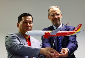 Vietjet’s CEO Dinh Viet Phuong and Airbus EVP Sales Commercial Aircraft Benoit de Saint-Exupery pose for photos during a signing ceremony at the Singapore Airshow at Changi Exhibition Centre in Singapore February 22, 2024.
